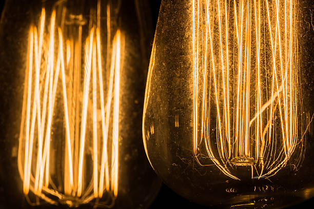 istock Vintage Edison Light Bulbs hanging against a black background 518550994