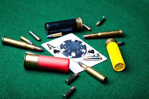 This is a photograph expressing the danger of gambling.  Illegal gambling could get you shot!