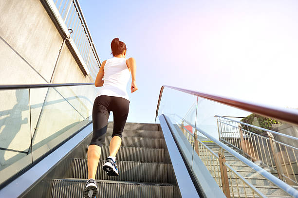 istock Runner athlete running on escalator stairs. 518552083
