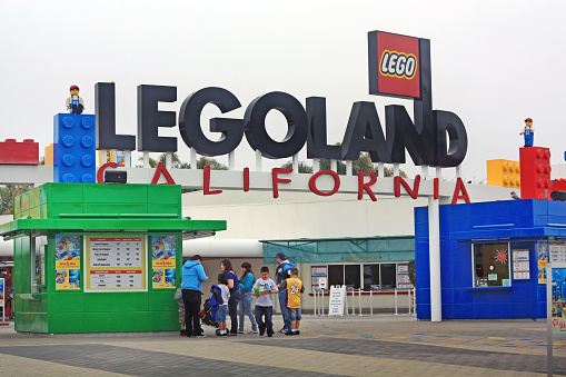 Carlsbad, CA, United States - April 25, 2010: A family in line to buy tickets at the entrance of Legoland, a  theme park located in Carlsbad, California.