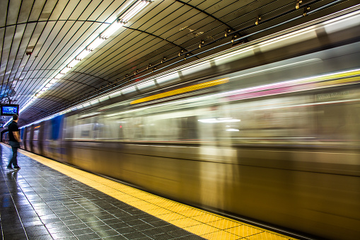 Fast moving train / subway with a man , long exposure