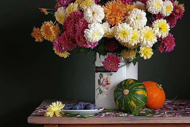 istock still life with chrysanthemums, plums and pumpkins 518555960