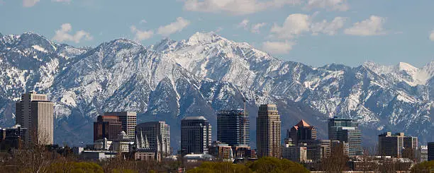 A 2.5:1 panoramic photo of the Salt Lake City skyline with the Wasatch Mountains in the background.