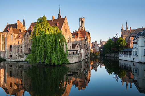 Bruges, Belgium. Image with Rozenhoedkaai in Brugge, Dijver river canal twilight and Belfort (Belfry) tower.