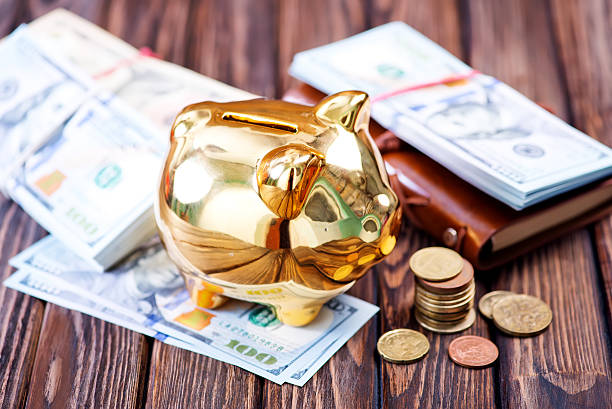 Pig money box golden on black background concept of financial insurance, protection, safe investment or banking. Close-up.