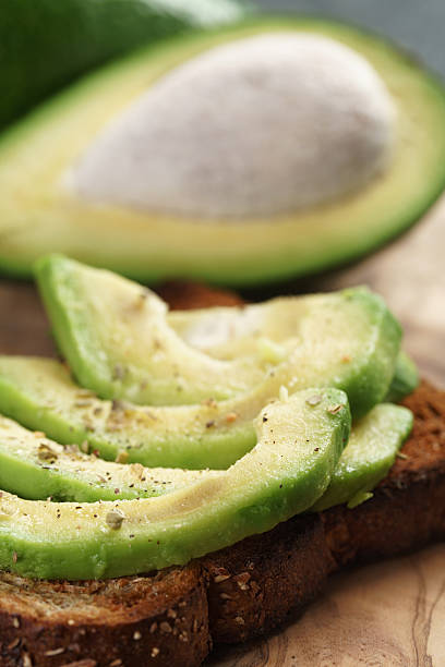 istock toasted rye bread with sliced avocado and herbs 518560308