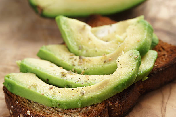 istock toasted rye bread with sliced avocado and herbs 518560328
