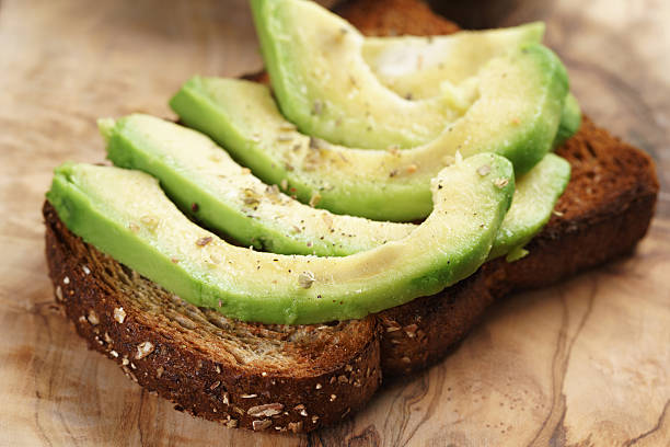 istock toasted rye bread with sliced avocado and herbs 518560360