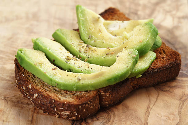 istock toasted rye bread with sliced avocado and herbs 518560402