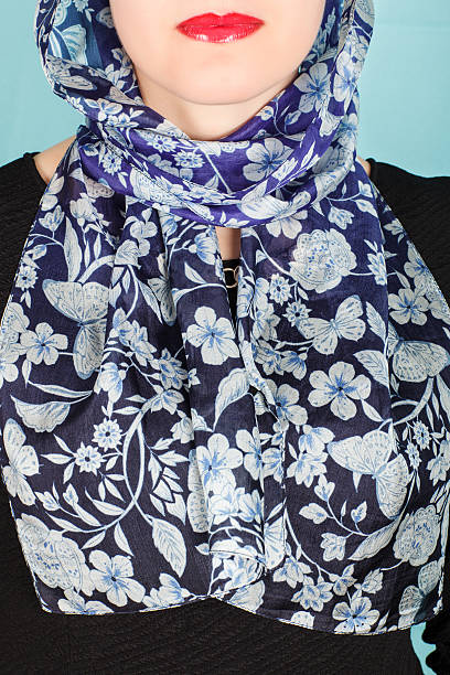 istock Silk scarf. Blue silk scarf around her neck isolated on blue background. 518563864