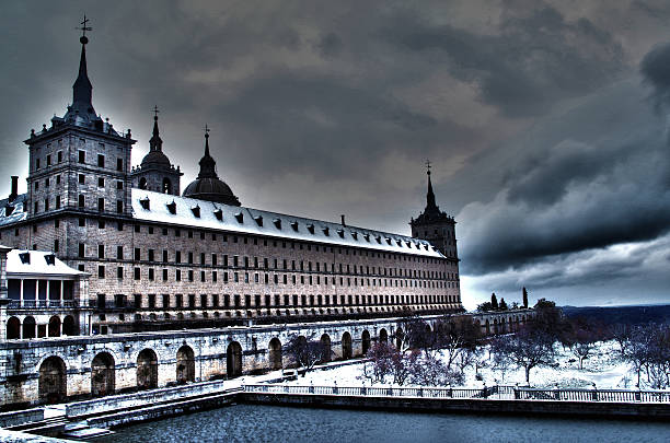 San Lorenzo de el Escorial Monastery on a stormy day. The south face under a snow layer.