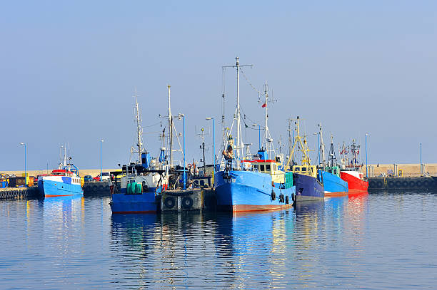 istock Fishing Boats in a Harbour and a Blue Sky 518564931