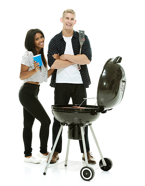 istock Smiling couple together by the barbecue grill 518566935