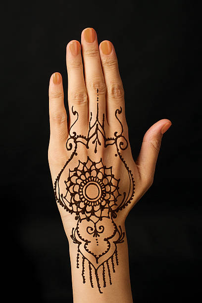 istock hand with mehendi on black background 518569321