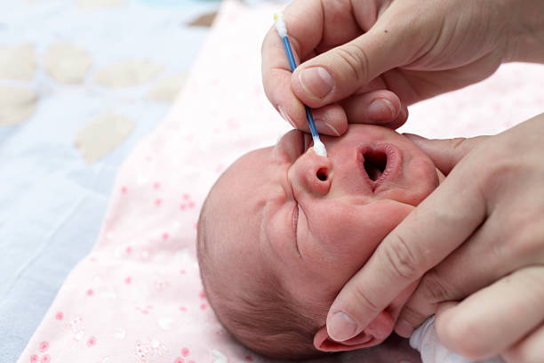 istock Cleaning the nose a crying baby 518586002
