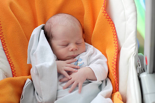 istock Baby boy sleeping in the chair 518586180