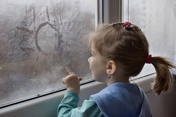 istock girl draws on glass 518587980