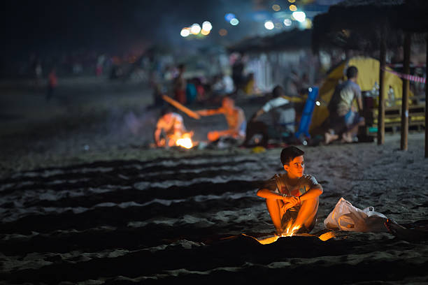 Mijas, Spain - June 23, 2015: Boy kindles a fire during Sant Joan holiday. It is one of the most important holiday in Spain. The fire is the symbol of the festival.