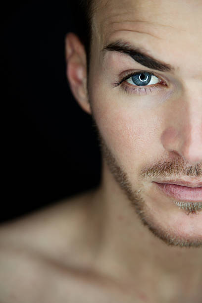 istock Portrait of a beautiful young man half face 518589363