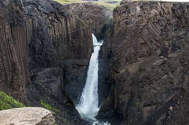istock Majestic waterfalls with rocks and grass around 518589481