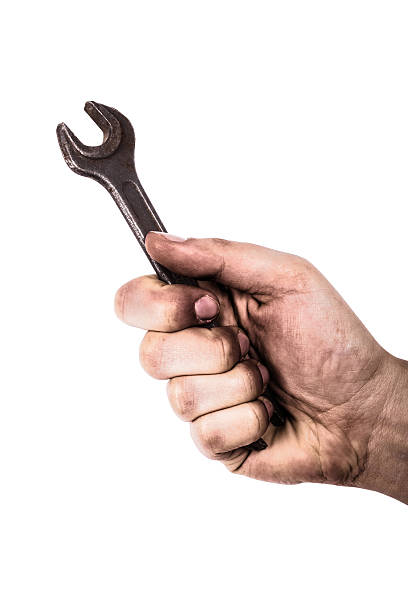 istock Dirty hand holding wrench isolated on white background 518590602