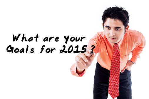 Young business person writes a question of goals in 2015