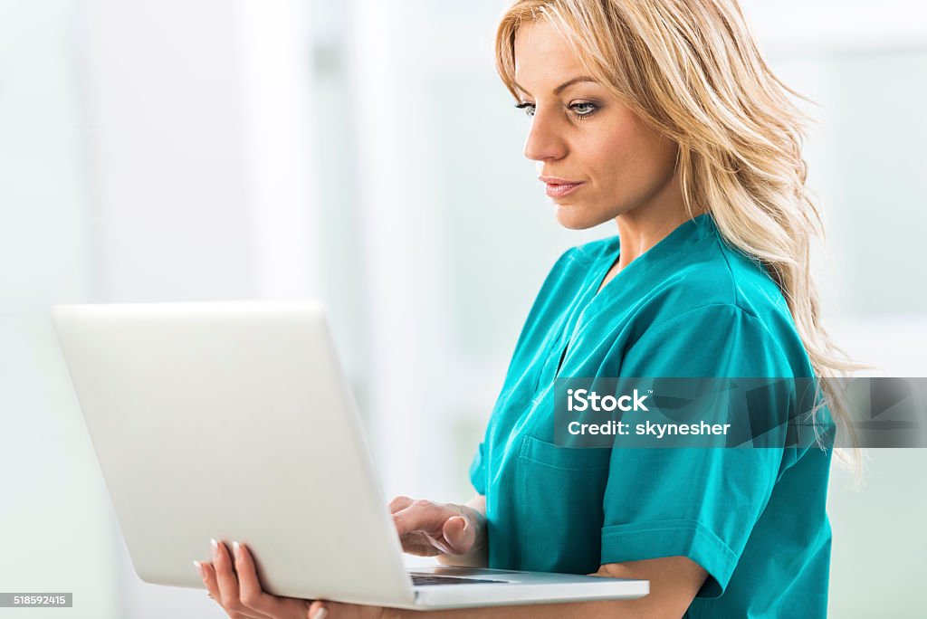 Surgeon Using A Computer Female Surgeon Using Computer Stock Photo - Download Image Now - Nurse ...