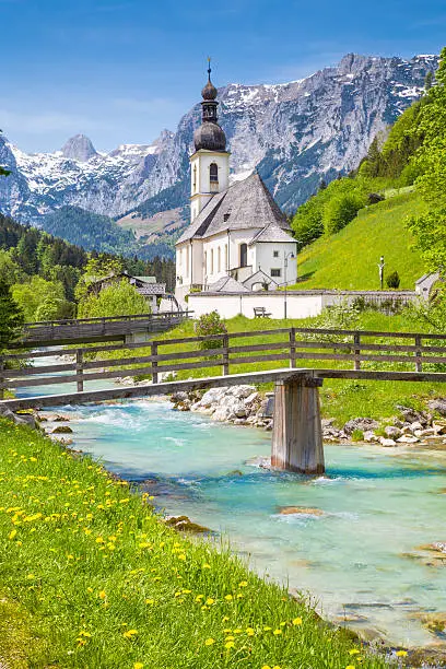 Scenic mountain landscape in the Bavarian Alps with famous Parish Church of St. Sebastian in the village of Ramsau in springtime, Nationalpark Berchtesgadener Land, Upper Bavaria, Germany.