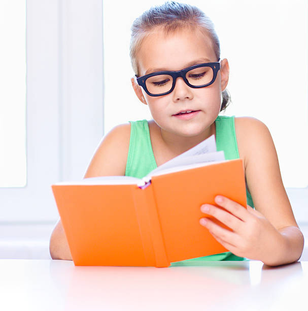 istock Little girl is reading a book 518594059