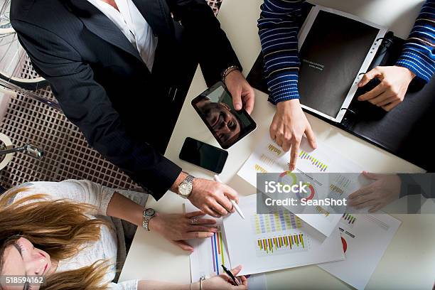 Working Group Analyzing Reports Stock Photo - Download Image Now - Wealth, Manager, Organization