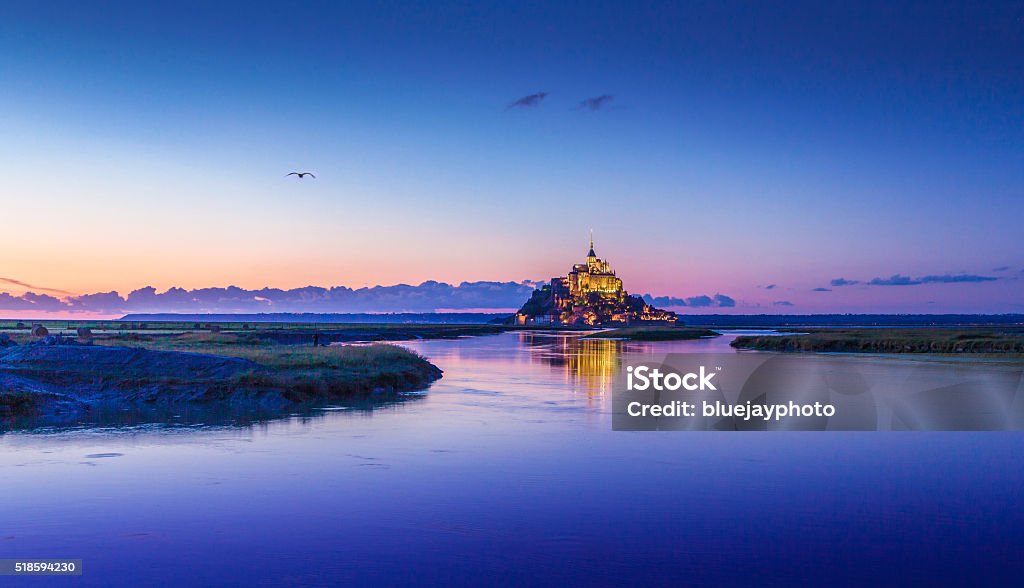 Mont Saint-Michel in twilight at dusk, Normandy, France Panoramic view of famous Le Mont Saint-Michel tidal island in beautiful twilight during blue hour at dusk, Normandy, northern France Mont Saint-Michel Stock Photo