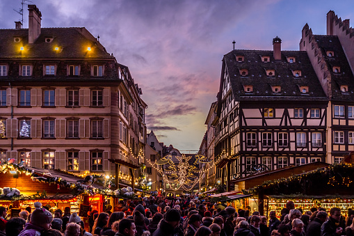 Strasbourg, France - December 8, 2013 - Crowds walk up Rue Merciere to the Christmas Market at dusk on December 8, 2013 in Strasbourg.