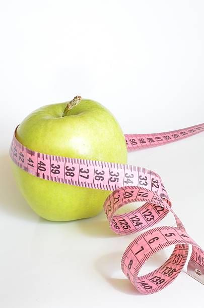 istock Apple wrapped with measuring tape 518595794