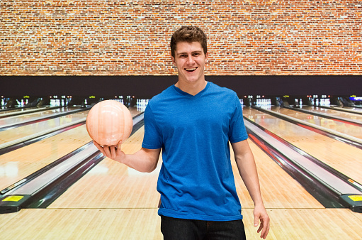 Smiling male holding bowling ballhttp://www.twodozendesign.info/i/1.png