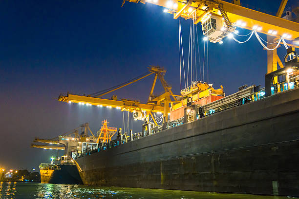 istock Cargo ship in the harbor at night 518596922