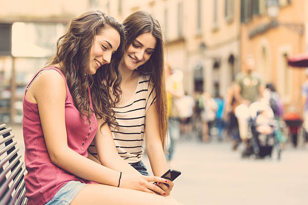 istock Two girls looking at a smartphone 518599178