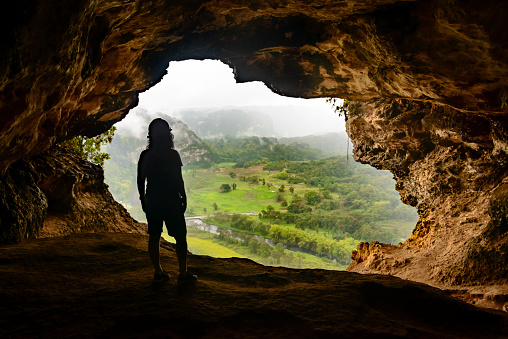 Woman admiring the view from Window Cave (Cueva Ventana) in Puerto Rico. Cueva Ventana (\