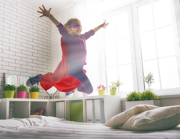 istock girl plays superhero 518617552