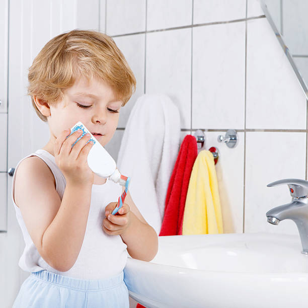 istock Lovely toddler boy brushing his teeth, indoors 518617594