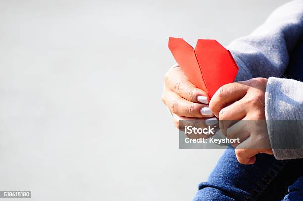 Hands Holding A Red Heart Shape Paper Stock Photo - Download Image Now - Heart Shape, Women, Teenager