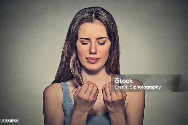 Worried Woman Looking At Fingers Nails Obsessing About Cleanliness Stock Photo - Download Image Now