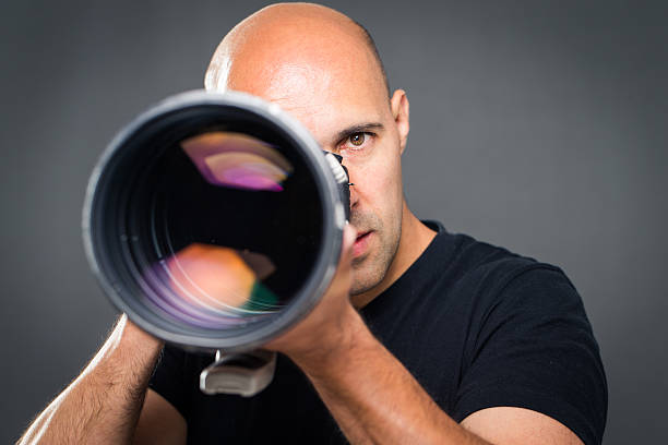 Young, pro male photographer in his studio