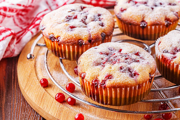 istock Cranberry muffins on a wooden background. 518620198
