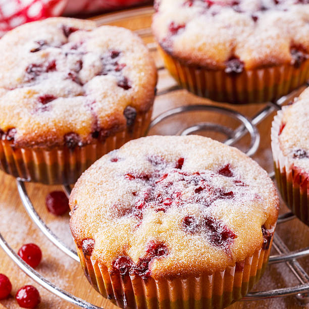 istock Cranberry muffins on a wooden background. 518620240