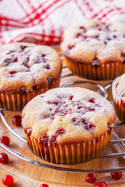 istock Cranberry muffins on a wooden background. 518620308