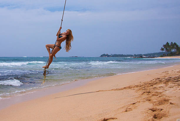 istock Woman  swinging at beach 518620538
