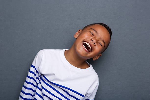 Close up portrait of a happy little boy smiling Close up portrait of a happy little boy smiling on gray background pre adolescent child stock pictures, royalty-free photos & images