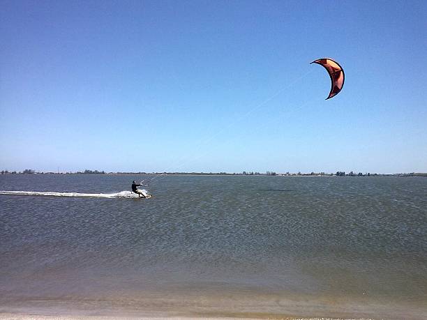 istock Kitesurfer sliding on the sea water 518621471