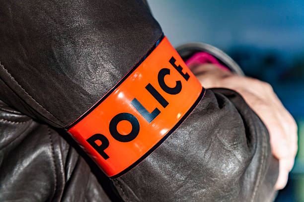 Close up on a  police officer wearing a Police armband