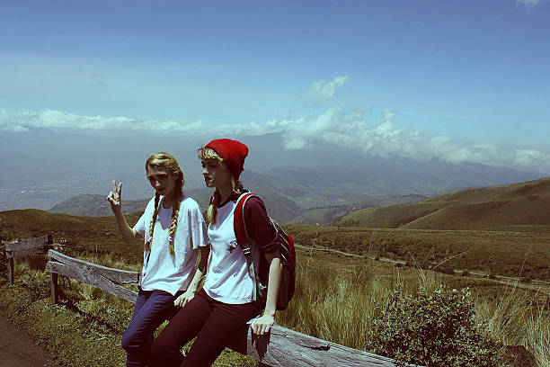 Two little girls holding hands while hiking together